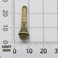 Bronze microphone alloy pendant for DIY jewelry making shown on a millimeter grid - Microphone-847