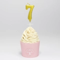 Golden number 7 birthday candle with holder on a decorative pink cupcake - Number 7