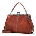 Vintage reddish brown kiss-lock handbag with distressed leather texture and floral metal frame - Brown