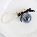 Preserved grey rose in glass ball keychain with white pearls and black ribbon bow - Gray