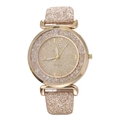 Detailed macro view of the gold quartz watch dial with glittering powder and rhinestones - Gold