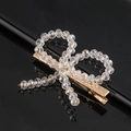 Detail of handmade bow hair clip with transparent faceted beads on golden metal base - Crystal Butterfly Flower
