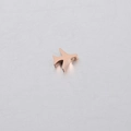 Macro view of a rose gold stainless steel airplane bead with a polished mirror finish - Rose Gold
