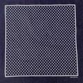Close-up of navy blue cotton bandana featuring white polka dots and 100% cotton mark - Navy Small Dots