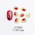 Detailed view of red oval nail crystal in gold alloy setting with pearls and rhinestones - Gold Base Red Rhinestone (2803)