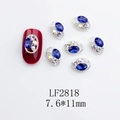 Detailed view of dark blue oval nail charms with silver alloy edges and crystal accents - Japanese Style Oval Nail Charm (2818) / 10 Pieces Pack
