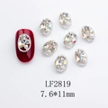 Detail of silver oval hollow nail charms with opal rhinestones and pearls on red nails - Japanese Style Oval Nail Charm (2819) / 10 Pieces Pack