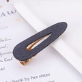 Macro detail of tear-shaped blue glitter hair clip with metallic gold base - Glitter Black Waterdrop