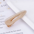 Close-up of a teardrop-shaped hair clip with sparkling gold glitter on a mesh background - Glitter Gold Waterdrop