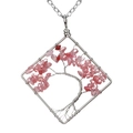 Macro view of handmade wire wrapped tree of life necklace with pink crystal stones - Watermelon red
