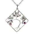 Macro detail of handmade wire-wrapped square tree of life pendant with colorful stones - Fluorite
