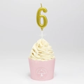 Golden number 6 candle with metallic finish on a decorated pink cupcake - Number 6