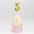 Golden number 5 birthday candle with metallic finish and plastic stand on a cupcake - Number 5