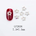 Detail of silver star nail charms with AB rhinestones on red nails, size 7.3mm - Silver Star AB Stone Style (LF2838)