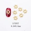 Detail of 8.6x9.6mm golden star nail charms with pearls shown on a red nail surface - Gold Hexagram Pearl Style (LF2857)