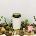 White solar garden light cylinder with gold trim on decorative pebbles with pink flowers - Cemetery Ornament (White)