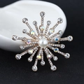 Golden sunburst brooch with a central pearl and sparkling aurora borealis rhinestones - xz4543 Radiant Snowflake