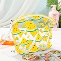 Macro view of clear PVC makeup bag with yellow watermelon print and secure yellow zipper - Yellow