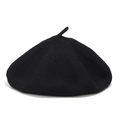 Detailed close-up of a black knit wool beret showing stitching and top pip detail - M (56-58cm) / Black
