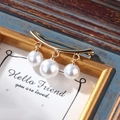 Elegant gold flower brooch with three hanging white pearls on a vintage background - xz4313A Gold Dangle