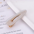 Detailed macro view of silver glitter hair clip with golden metal base for women - Glitter Silver Waterdrop