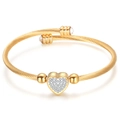 Golden cable twist open cuff bracelet with micro-paved heart charm and clear zircon accents - Gold With Zirconia