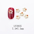 Close-up of golden star nail art charm with AB rhinestones and red gem, size 7.3mm - Gold Star AB Stone Style (LF2835)
