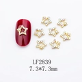 Close-up of gold star nail charms with iridescent rhinestones on white background - Gold Star Colorful Stone Style (LF2839)