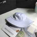 Detailed texture of white cotton bucket hat placed on a magazine with lifestyle accessories - 8cm Brim/With Windproof Rope / White