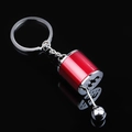 Detail shot of a red and silver manual gear shifter car keychain on black background - Bright Red Gear Shifter