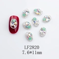 Macro shot of oval nail art alloy charms with mint green rhinestones and pearls - Japanese Style Oval Nail Charm (2820) / 10 Pieces Pack
