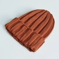 Classic knitted beanie hat in warm caramel orange color for adults made of thick wool - One Size / Rust red