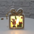 Close-up of a wooden glowing Christmas gift box ornament with warm yellow LED lights inside - Gift Bag Style