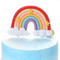 Rainbow and cloud cake topper with yellow stars on a blue cream frosted birthday cake - Red Star Polymer Clay Rainbow