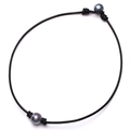 Detail of black leather cord choker featuring two large dark grey pearls tied at ends - Single Pearl Necklace / Black