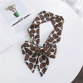 Long paisley print silk scarf tied in a bow with red and blue patterns on beige background - White Paisley