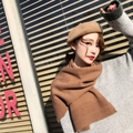 Detailed knit texture of a brown winter scarf worn by a model in a stylish look - Caramel