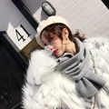 Chic grey ribbed knit scarf paired with a beige beret and white faux fur coat - Gray