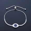 Macro shot of silver Evil Eye bracelet featuring blue crystals and white zircons detail - Evil Eye