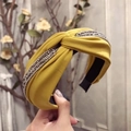 Cross-knot fabric headband in bright yellow featuring sparkling silver rhinestone details - Yellow