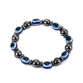 Close-up of 8mm magnetic hematite beads with blue evil eye charms on white background - Oval Evil Eye Beads