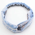 Blue and white floral elastic headband with crossover design and textured fabric finish - Ethnic Light Blue Floral