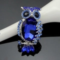 Detailed close-up of a royal blue owl brooch with crystals and hollow metal work - Royal Blue (B029-A)