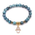 Blue spotted stone beaded bracelet with golden Hamsa hand pendant on white background - Blue Spotted Stone (Hamsa Hand)