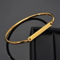 Detailed view of polished gold plated cuff bracelet with custom engraved rectangle plate - Gold