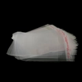 Macro shot of stacked transparent OPP self-adhesive bags with red resealable flap text - 5x7cm/200pcs/3.5 Silk