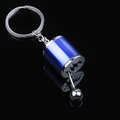 Blue manual gear shifter car keychain with six-speed pattern on polished metal surface - Blue Gear Shifter