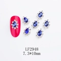 Macro detail of 7.3x10mm crown-shaped nail art rhinestones with teardrop blue sapphire glass - Waterdrop-LF2948 / Silver/Blue