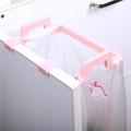 Pink cabinet door trash bag holder with panda design hanging on a white cupboard - Pink