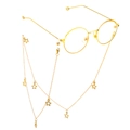 Close-up of golden round sunglasses frame with star pendant chain on a white background - Gold